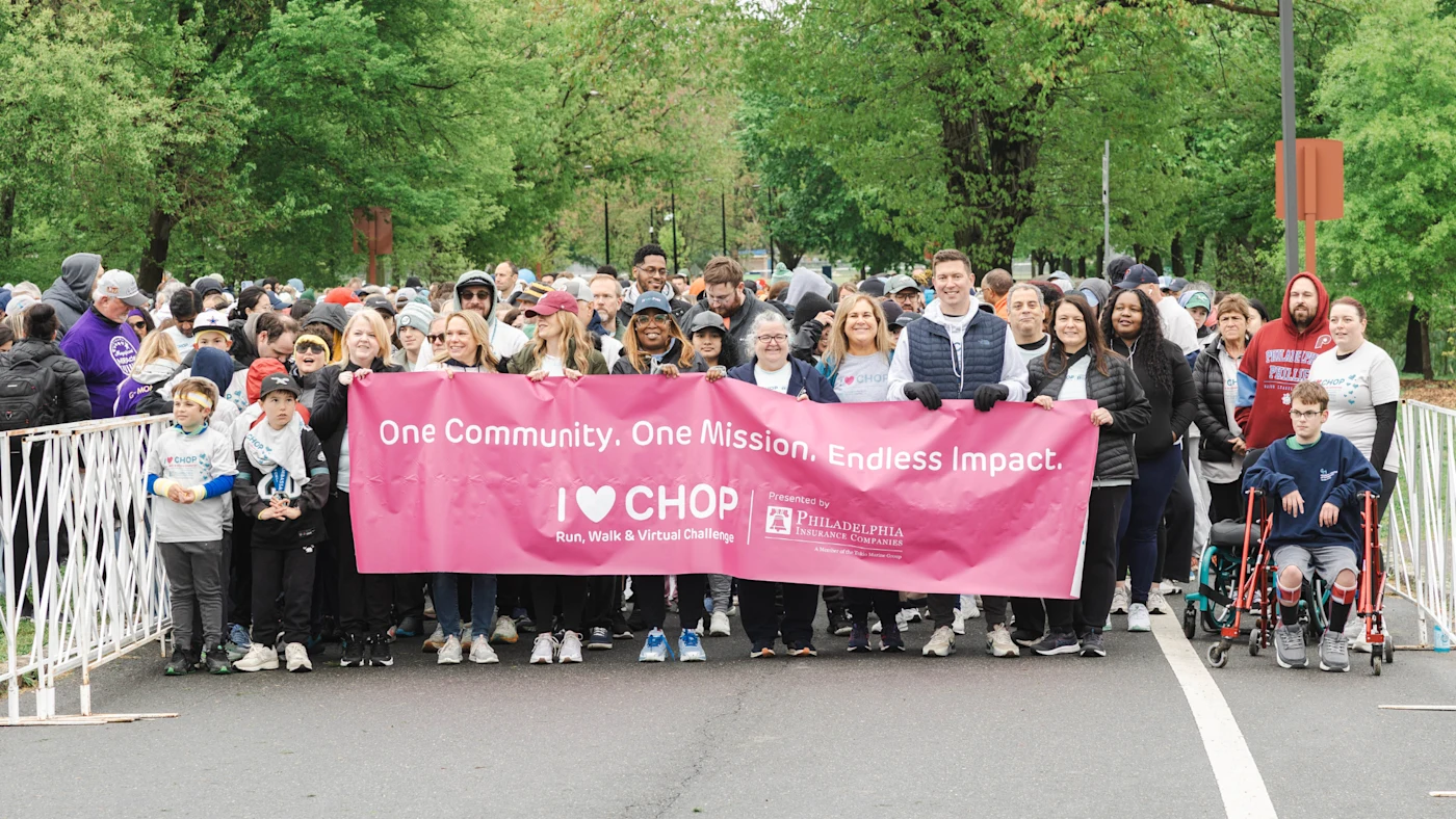 TEAMPHLY holds banner at the start of the I <3 CHOP pathway.
