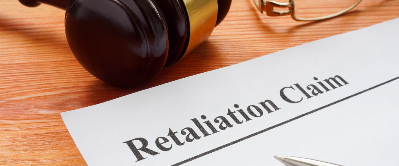 A gavel on a desk next to a document for a lawsuit for retaliation. 