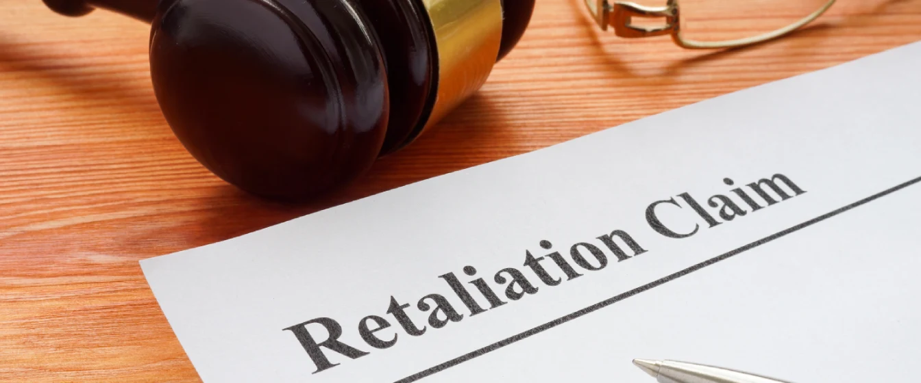 A gavel on a desk next to a document for a lawsuit for retaliation. 