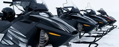 Close up images of snowmobiles lined up