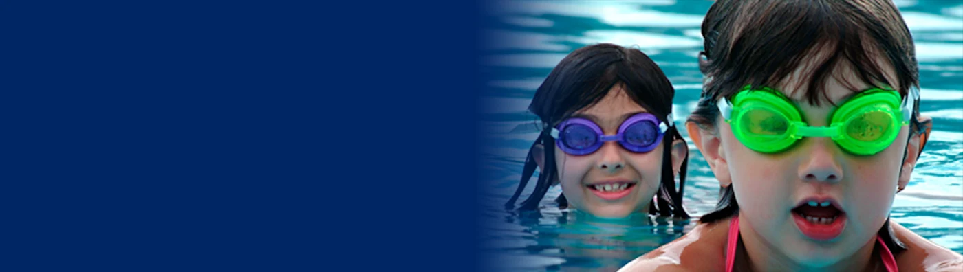 Two young swimmers in a pool - half the image is blurred out.