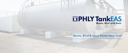 A row of large storage tanks in a factory concrete field, illustrating the need for storage tank pollution insurance.