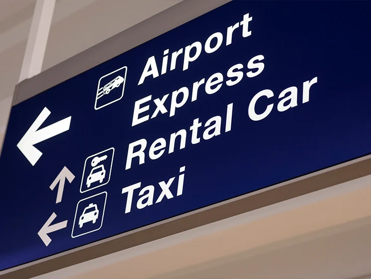 Close up of a directional sign pointing to express and rental car services.