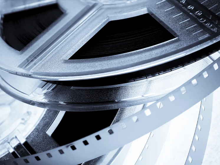 Close up image of a film reel with exposed strip.