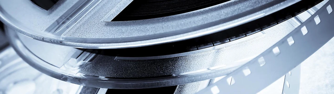 Close up image of a film reel with exposed strip.