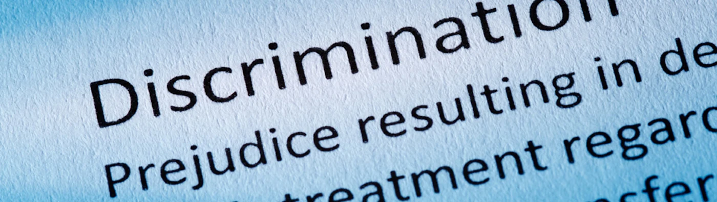 Close up image of printed text highlighting the word “Discrimination” on a document.
