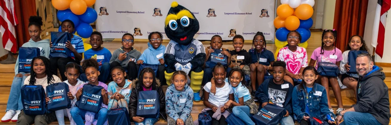 Kids with the Shoes that Fit mascot.