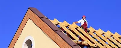 Image of construction worker on a half-built roof