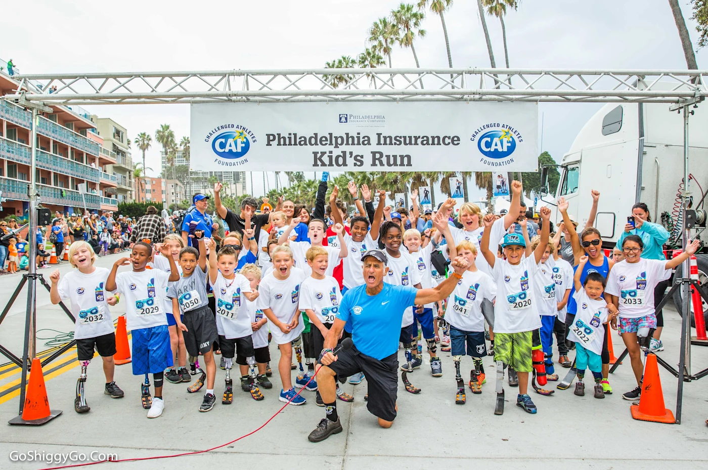 Challenged Athlete Foundation racers lined up to begin their race, cheering.