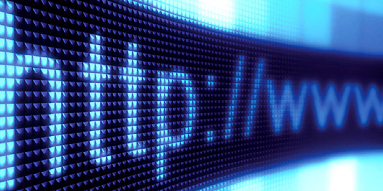 Close-up of a glowing blue digital screen displaying "http://www" in pixelated letters.