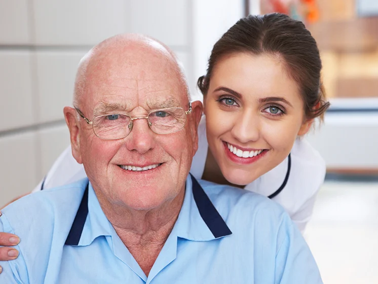 Image of a young female nurse with an older male patient