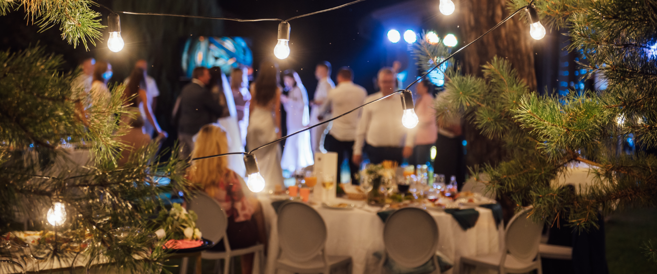 Guests celebrate a newly married couple at an intimate outdoor wedding.
