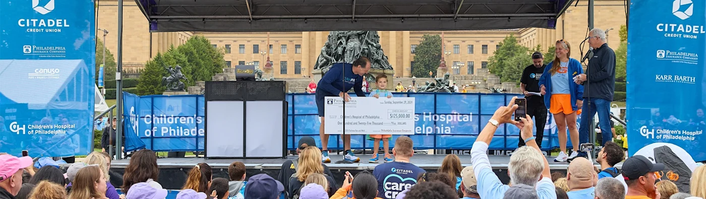 On the image John W. Glomb presents a check to child