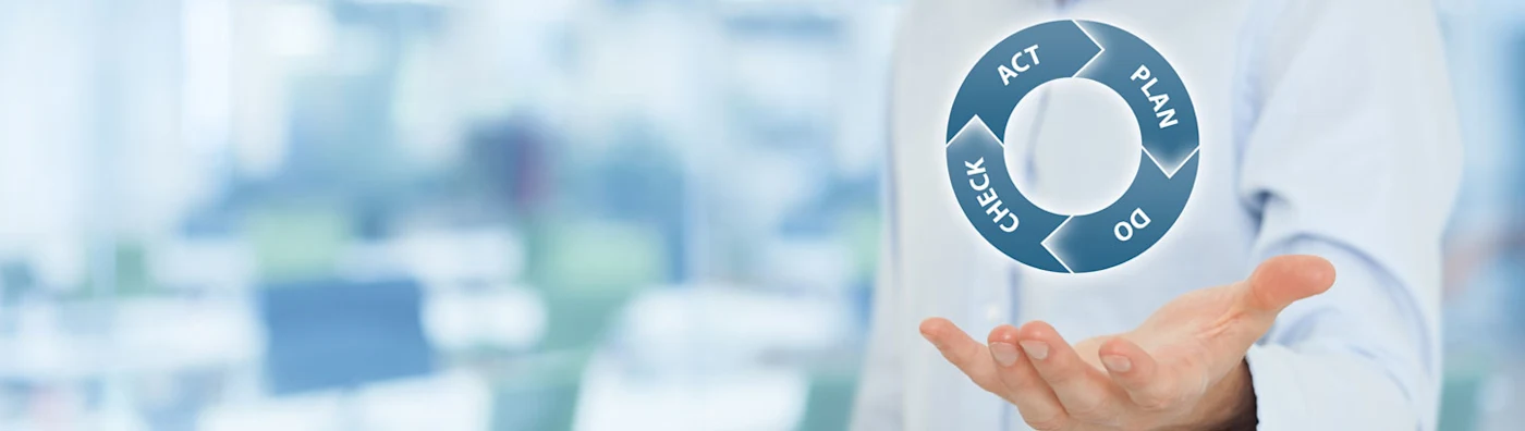 Disaster Planner Business Continuity Banner: A hand appears to hold aloft a graphic of a cycle of words: Act > Plan > Do > Check