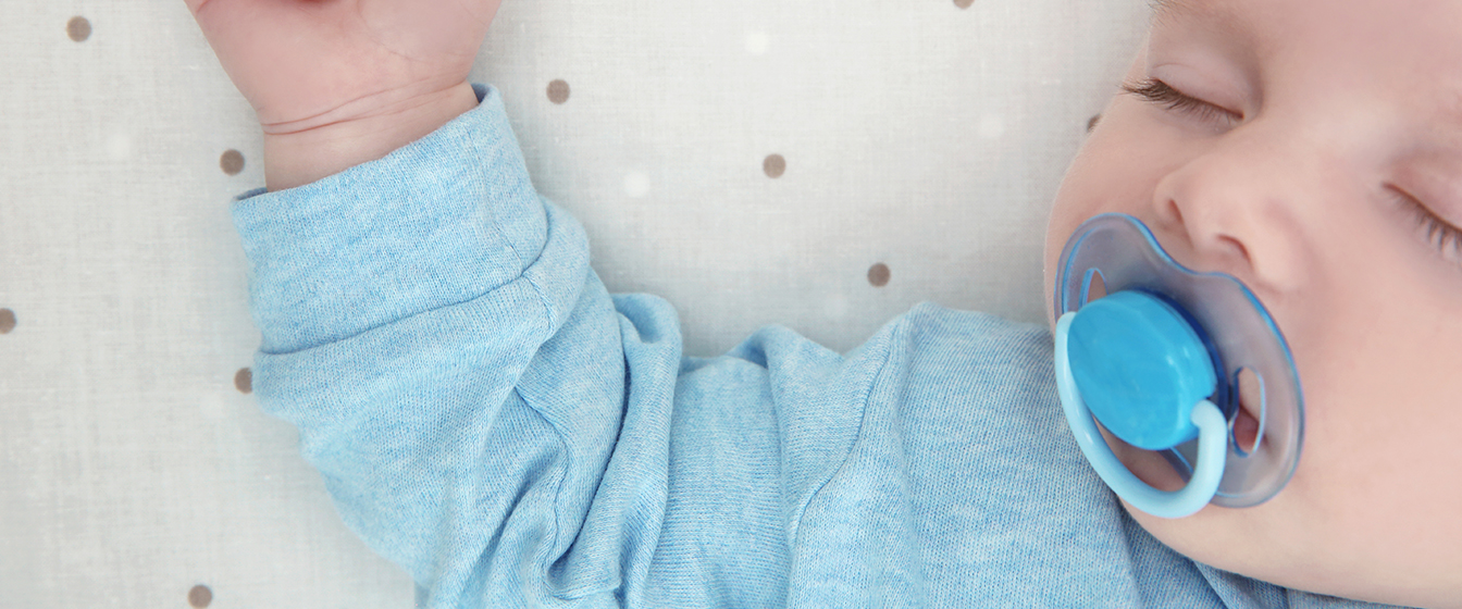 Close up of a baby in blue, sleeping