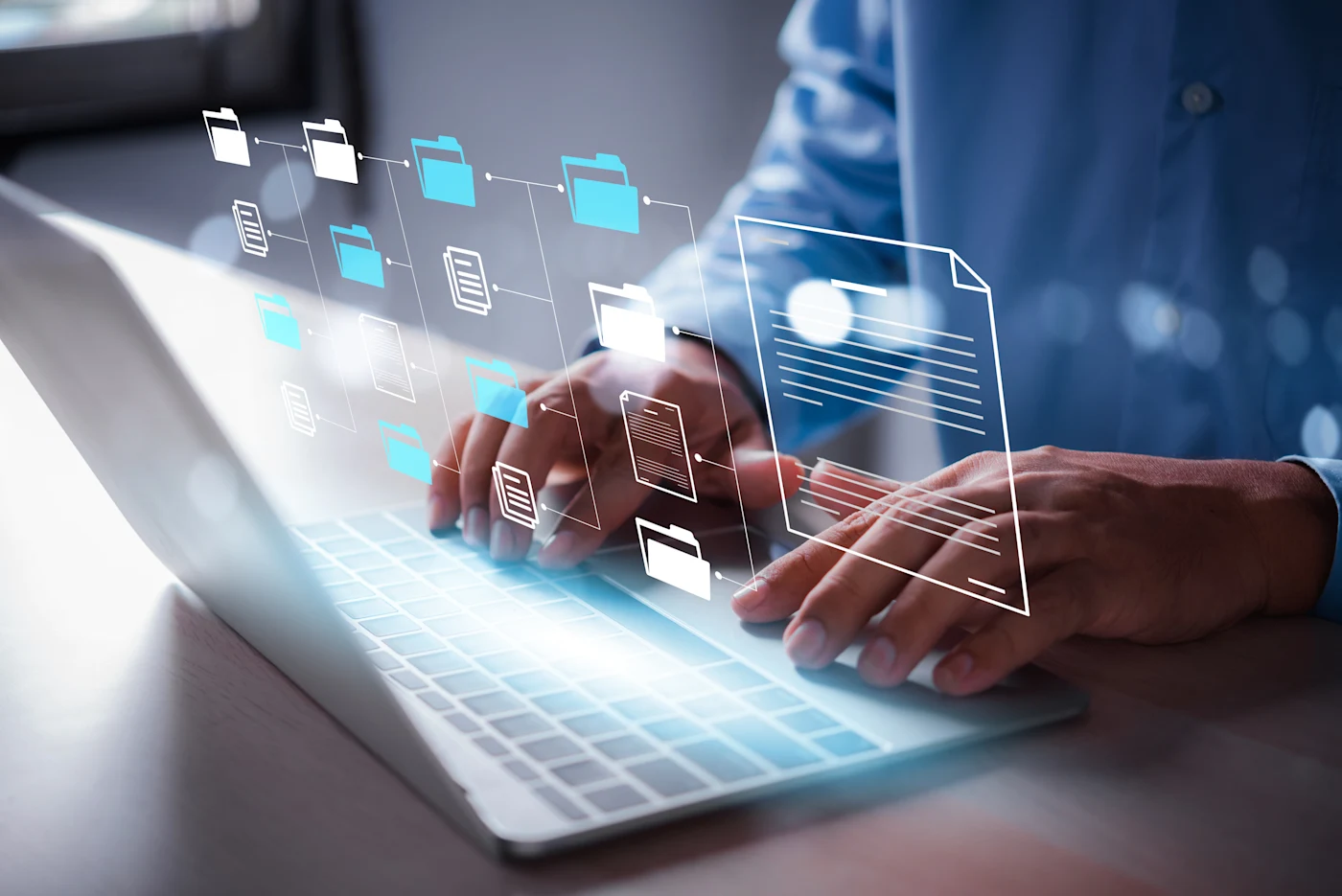 Man typing on a laptop to depict document management