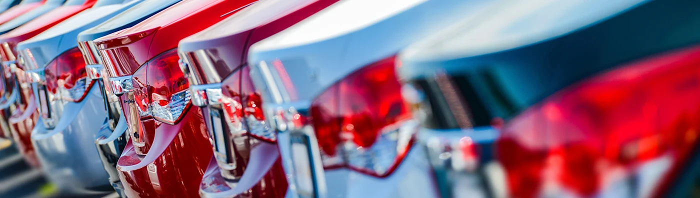 Row of cars, only taillight and trunk showing