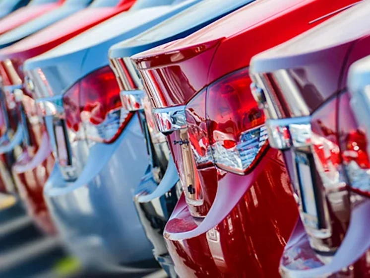 Row of cars, only taillight and trunk showing