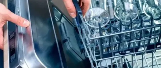 Opened dishwasher with dry wine glasses without water spots