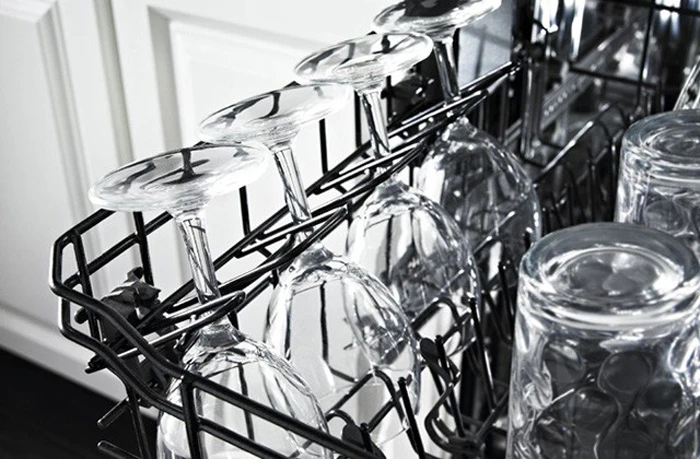 Top rack of dishwasher with spotless wine glasses