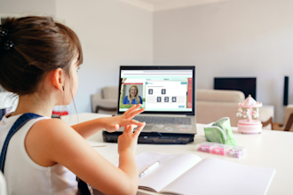 A girl is completing her online tuition session with Explore Learning from home