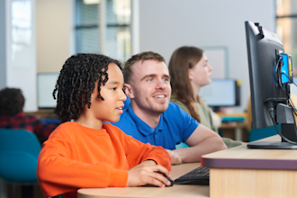 Tutor supporting a child with SATs preparation in an Explore Learning centre