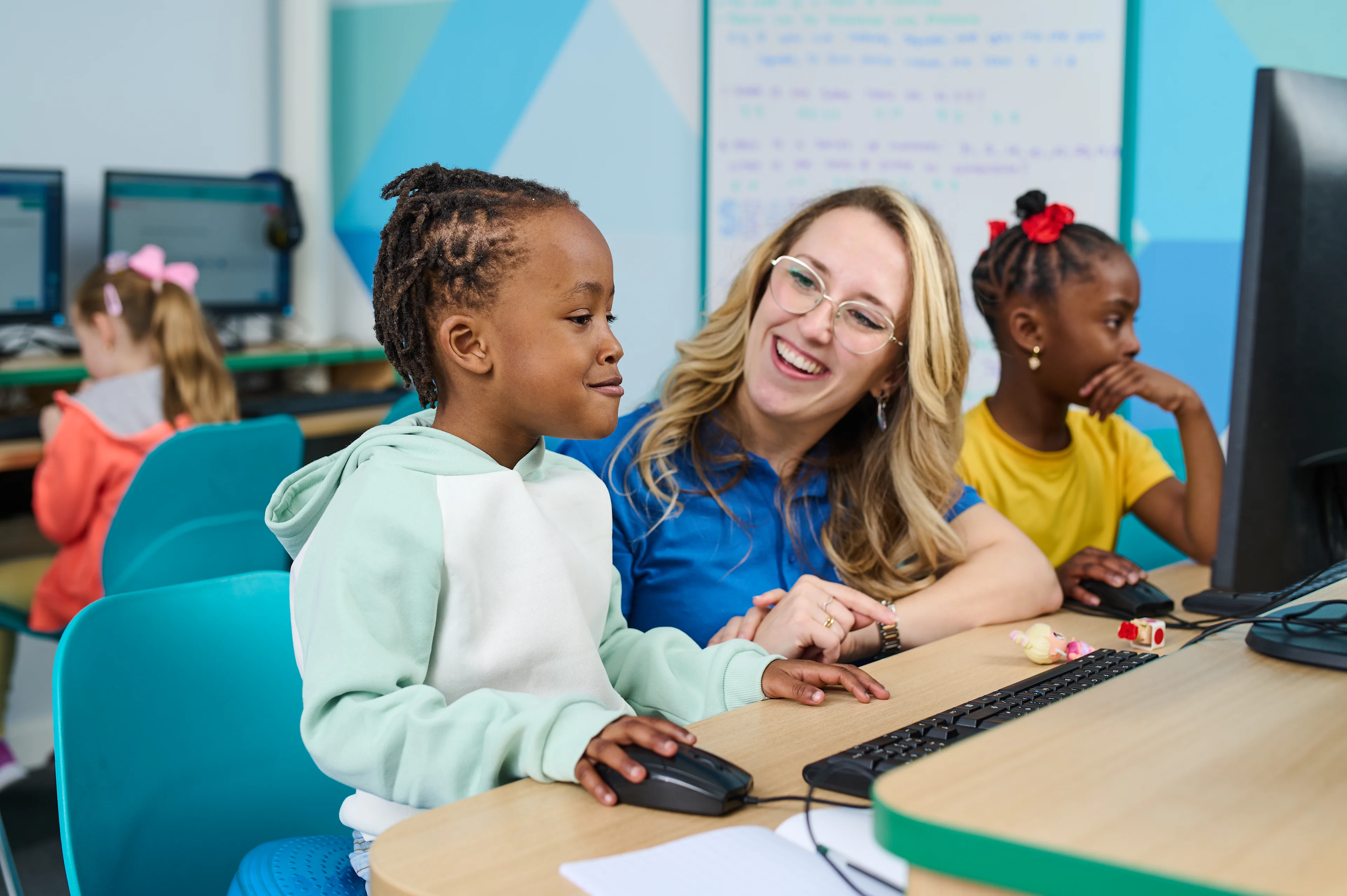 Tutor helping child to learn in an Explore Learning centre