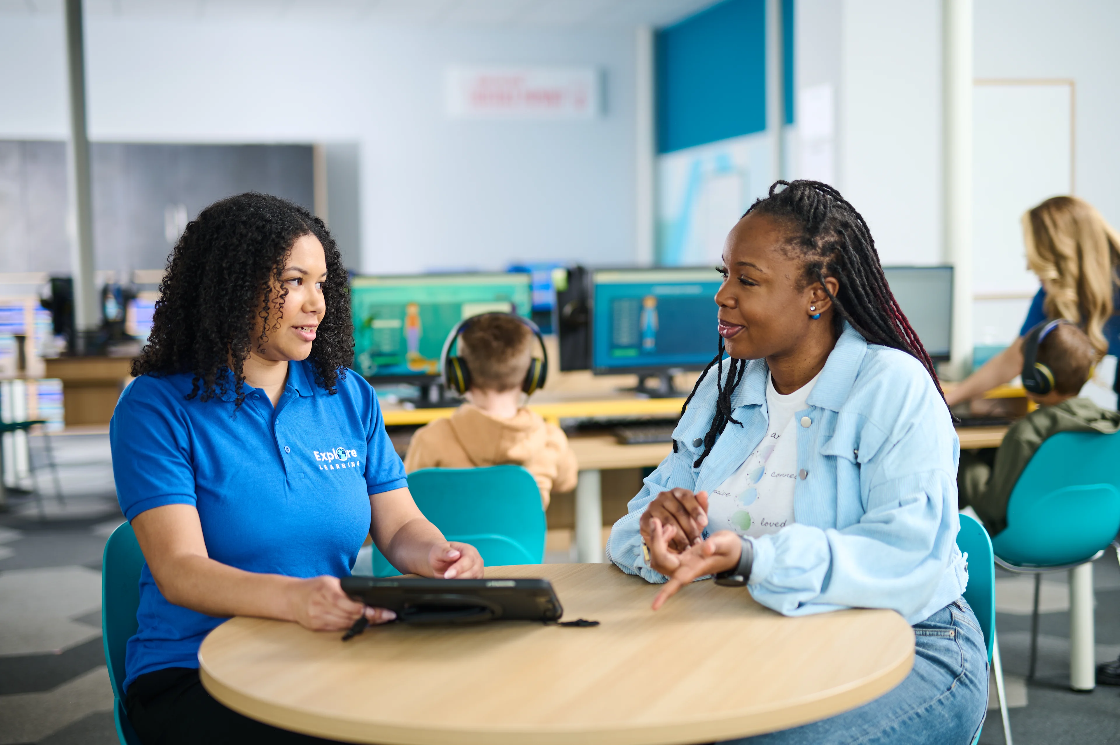 Tutor and parent discussing child's progress