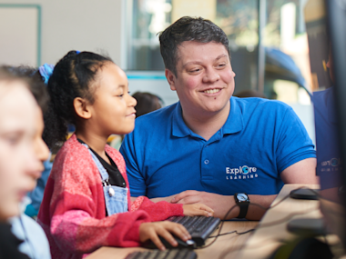 Photo of an Explore Learning tutor helping a child with Member Portal