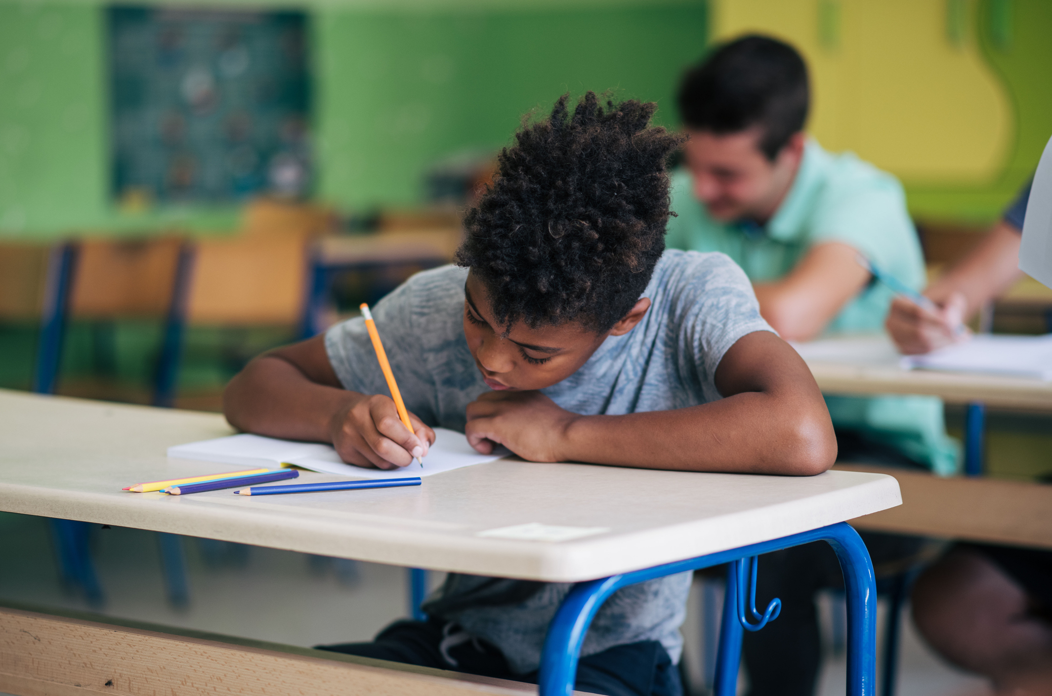 A child completing a SATs mock exam in a classroom