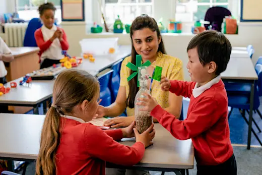 Children in primary school playing with a teacher