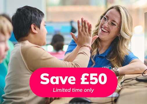 Tutor high-fiving child in an Explore Learning centre with a promotional save £50 badge