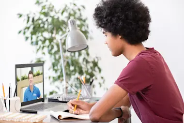 Boy sitting down to do his GCSE online tuition session with an Explore Learning online tutor.