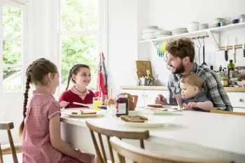 Dad in the kitchen with his children chatting