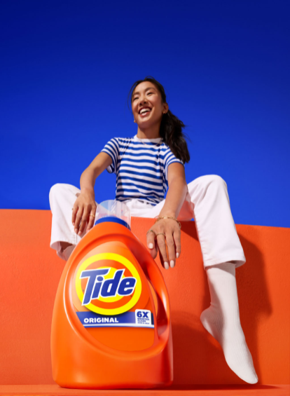 Woman sitting behind Tide liquid
