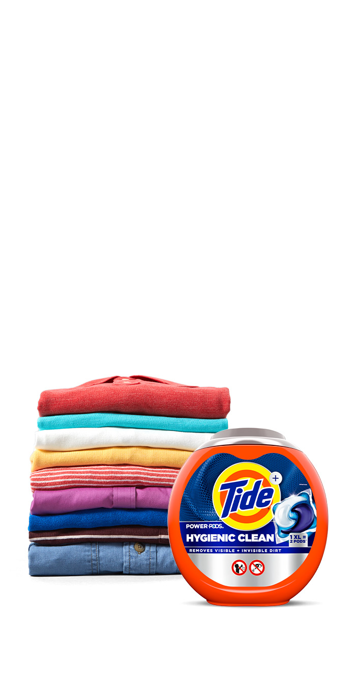 Tide Hygienic Clean Heavy Duty 10x Power PODS in front of a pile of folded colorful clothes