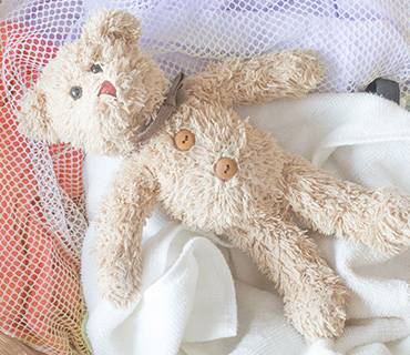 A teddy bear waiting to be washed