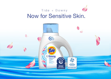 Tide Plus Downy Free Liquid Laundry Detergent shown surrounded by flower petals showing it's developed specifically for sensitive skin