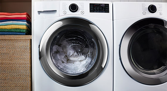 A frontal picture of an high efficiency washing machine in use