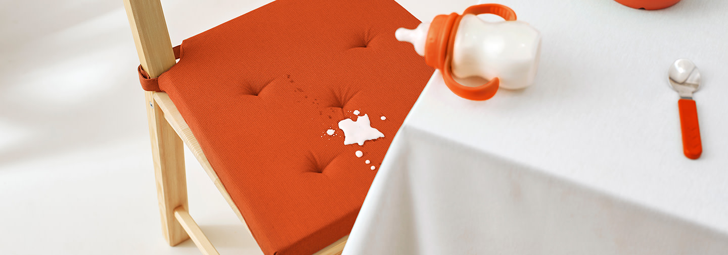 Baby formula stains on an orange chair cover