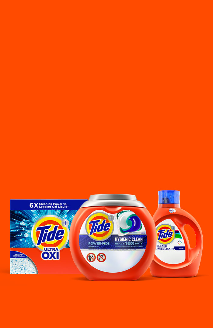 A range of Tide laundry detergent products in front of an orange background