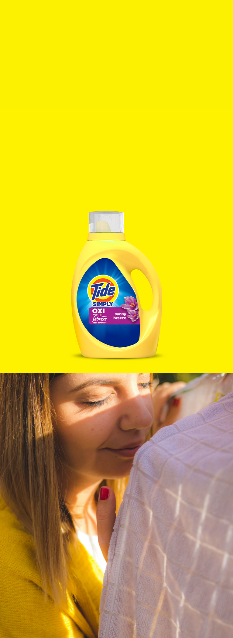 A woman enjoying the fresh scent of laundry thanks to the odor fighting technology of Tide.