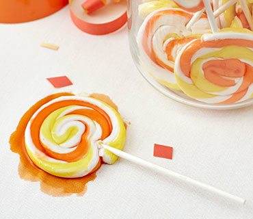 Melted swirl lollipop on white tablecloth