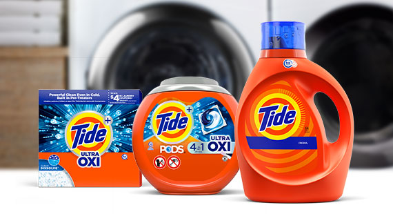 Tide powder, PODS and liquid products in front of a washer