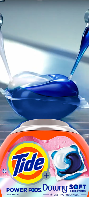 Tide PODS on an assembly line with a packshot of a Tide Plus Downy PODS box in the foreground.