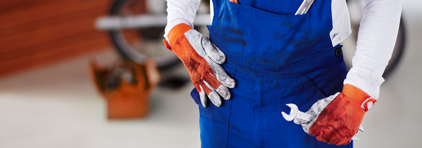 A person wearing oil-stained work clothes