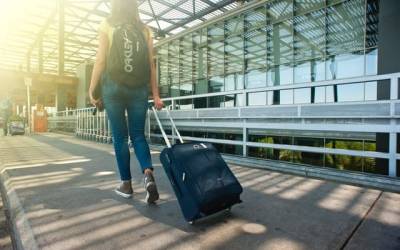 carrying luggage through the airport