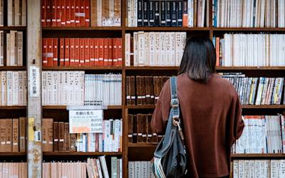 girl looking at books in the library