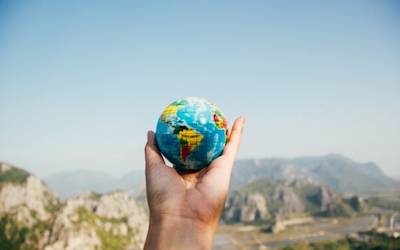 holding small globe in hands