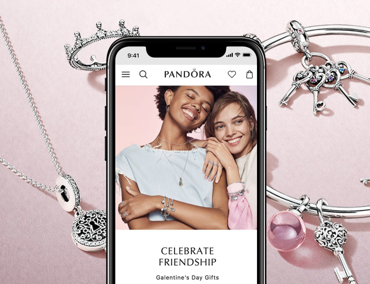 Pandora website shown on mobile device with bracelets and necklaces in the background